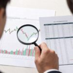 A person looking at a complex stock chart with a magnifying glass, while another person is confidently looking at a detailed financial report, showing the difference between price and value.