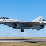 A sleek, modern KF-21 Boramae fighter jet performing a rapid take-off from a runway, with a clear blue sky in the background, symbolizing speed and efficiency.