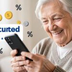 An elderly person smiling while looking at their smartphone with reduced phone bill notification, coins and percentage symbols floating around