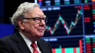 Warren Buffett looking thoughtfully at a stock market chart during a market crash, with a calm expression, in a realistic style with dramatic lighting.